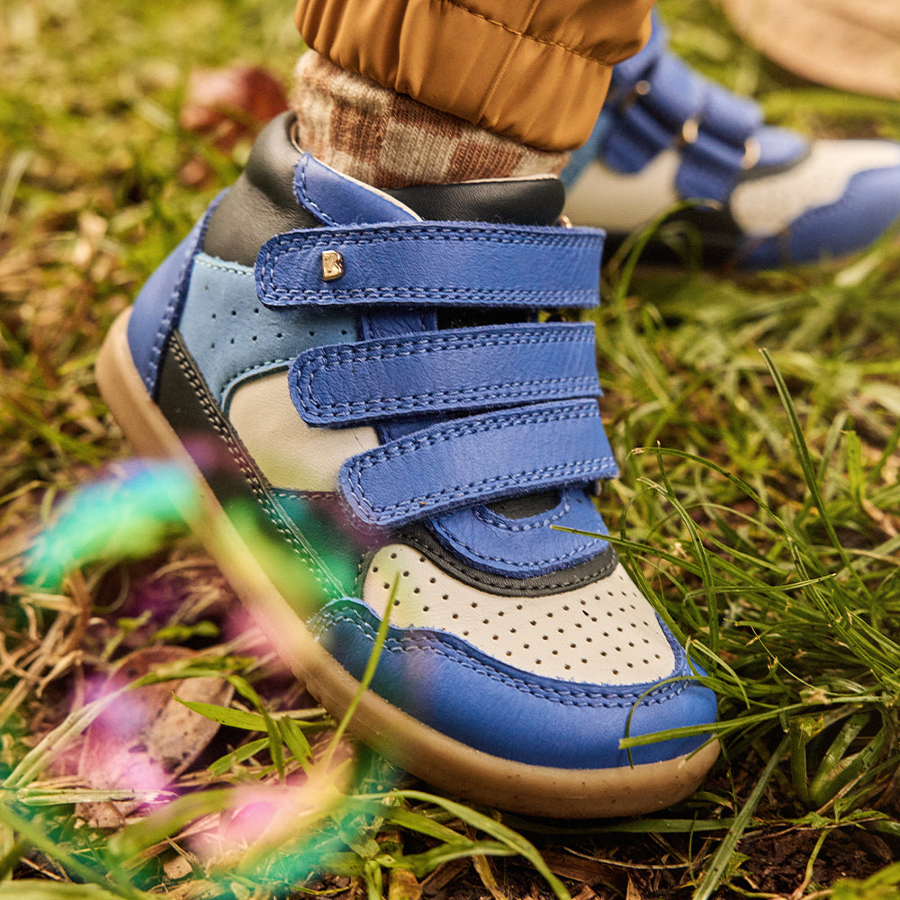 Image of a boy's foot wearing blue Bobux boots