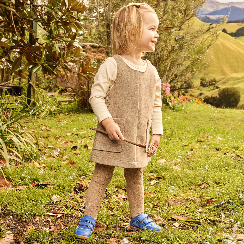 Image of a girl wearing blue Bobux trainers
