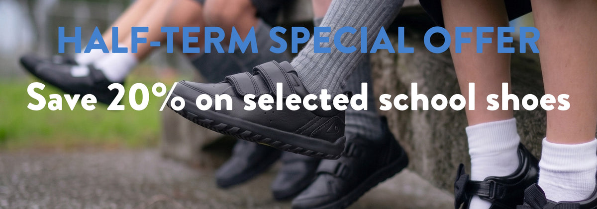 Promotional banner showing several children's feet wearing black school shoes, with large overlaid text reading 'HALF-TERM SPECIAL OFFER' and 'Save 20% on selected school shoes.'.