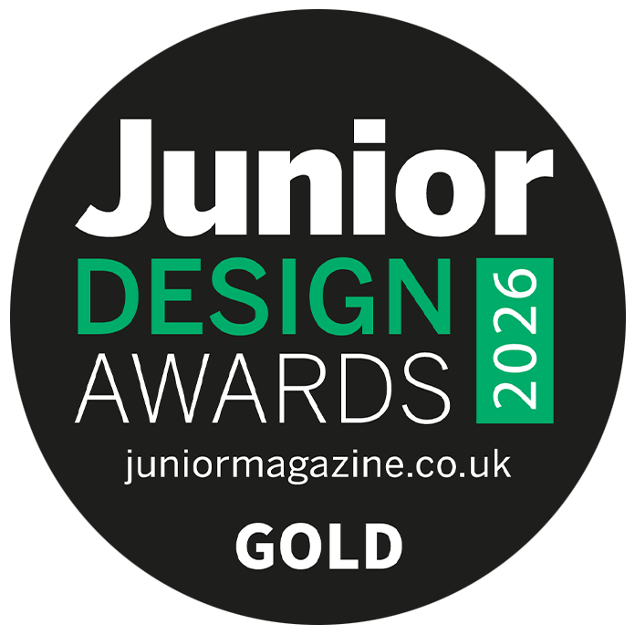 A circular black badge with white and bright green text reading 'Junior Design Awards 2026' and 'GOLD'.